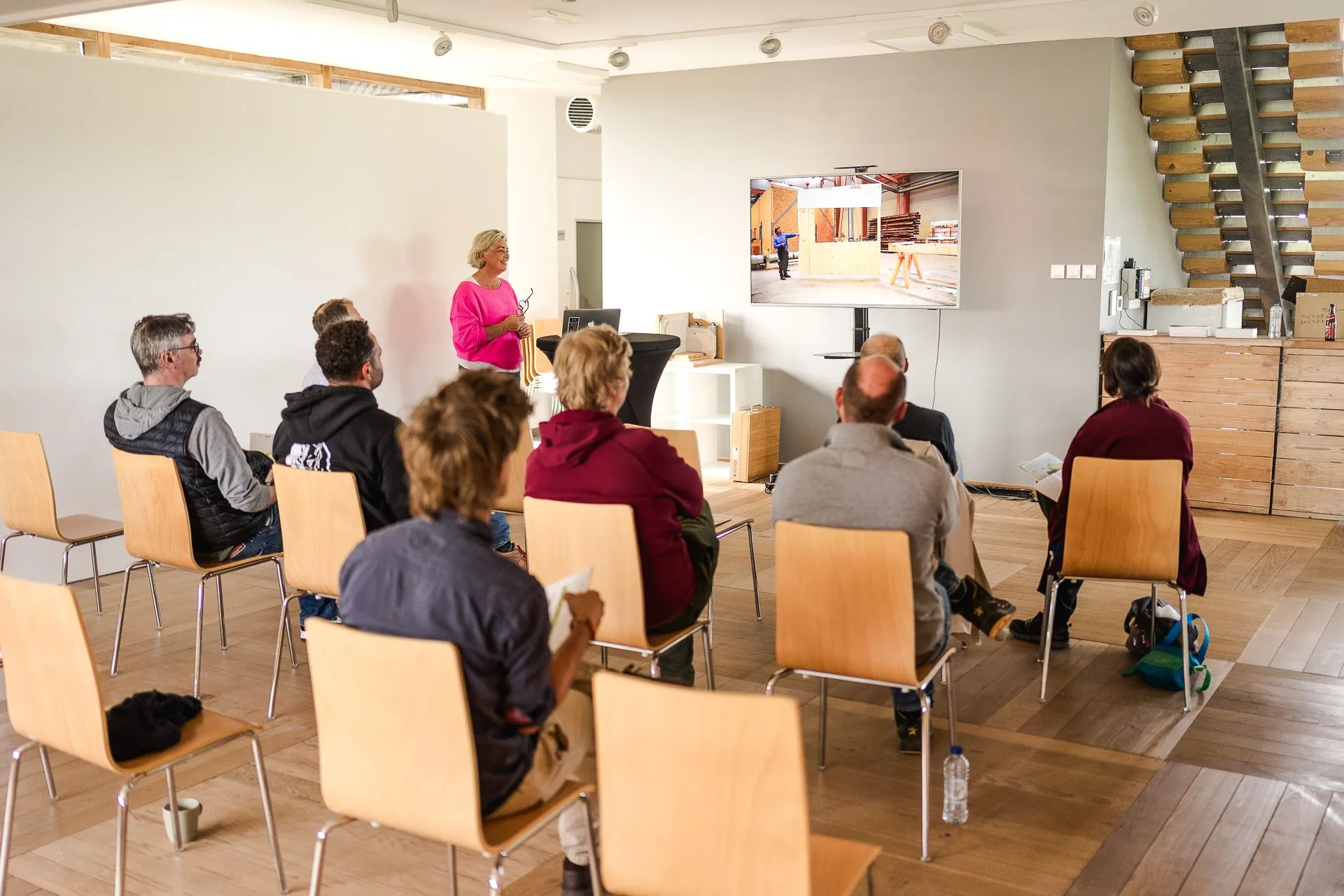 Anne-Michèle Janssen présente le Cluster Eco-construction aux participants, dans la salle de son bâtiment à Namur