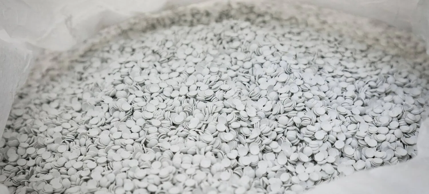 White recycled PVC granules in a bulk bag