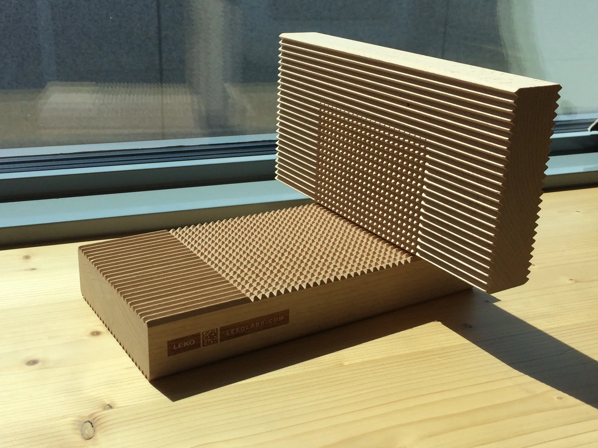 Leko Labs sample of timber with notched lamellas, resting on a window sill