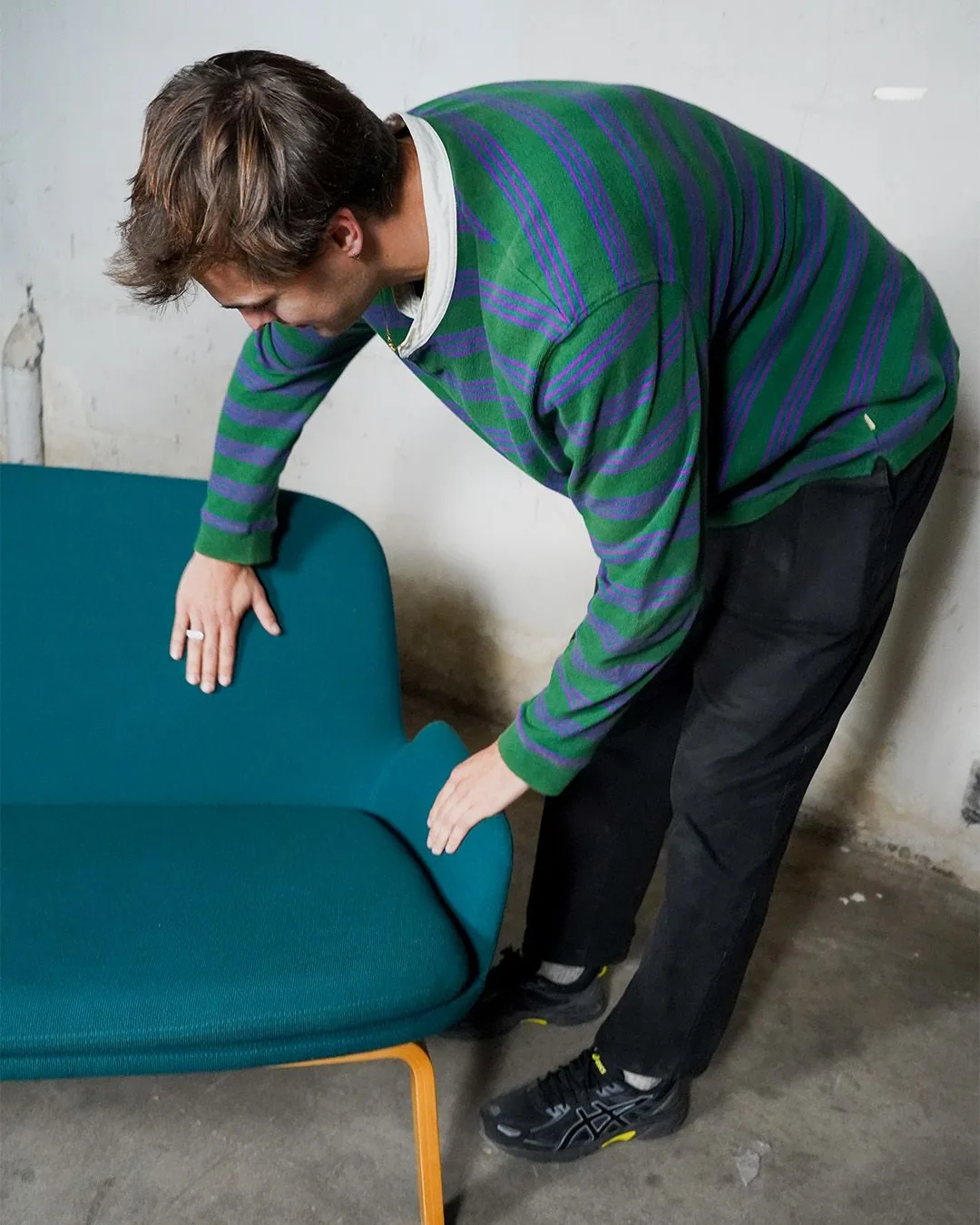 Member of the Relieve team checking a second-hand upholstered bench