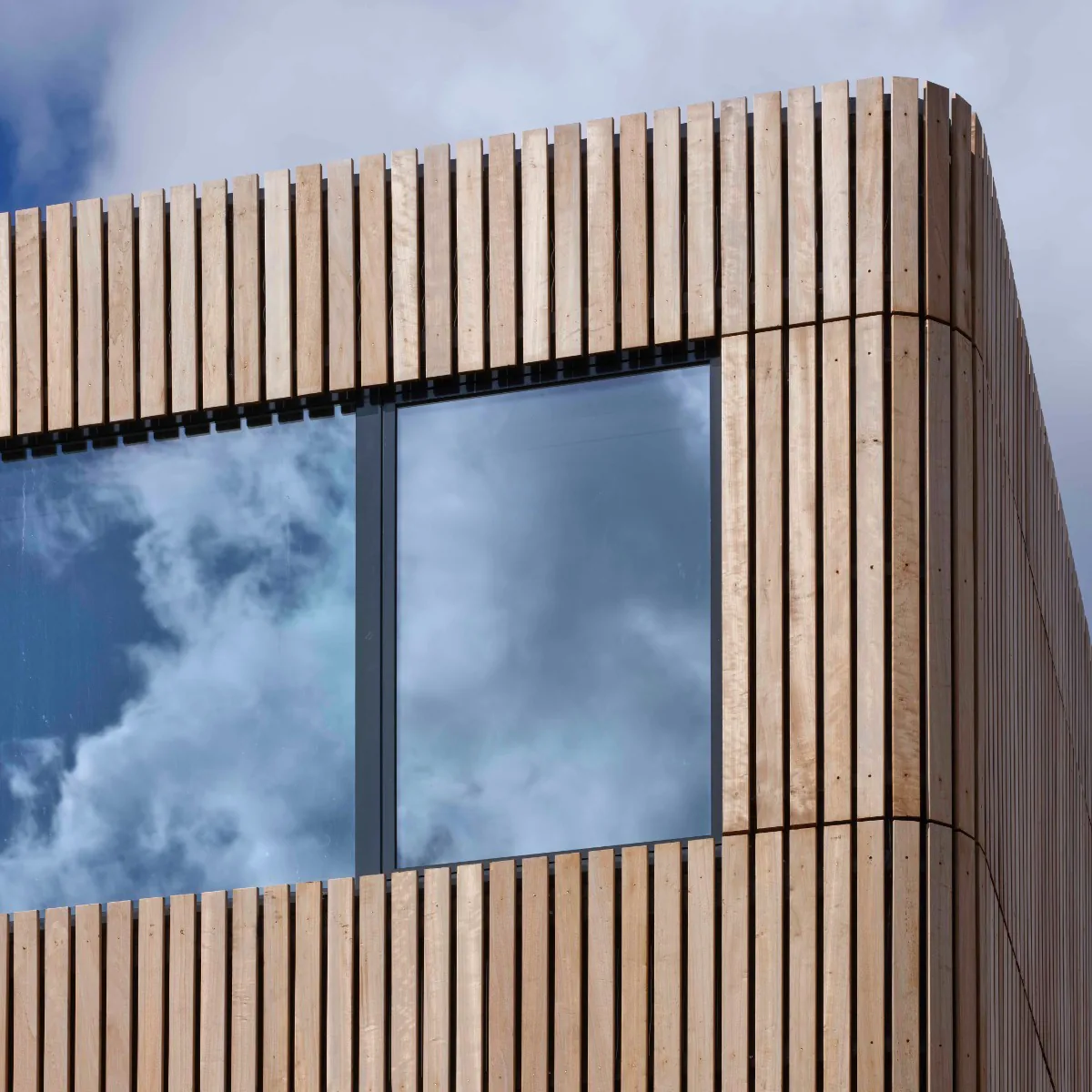 Corner of a facade in open-jointed platonised poplar boards